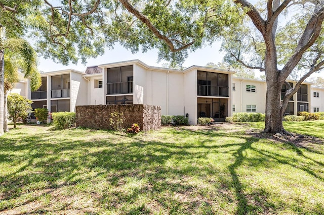 rear view of house featuring a yard