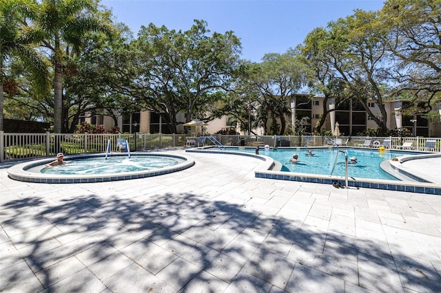 view of swimming pool with a patio area and a hot tub