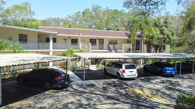 view of front facade with a balcony and a carport