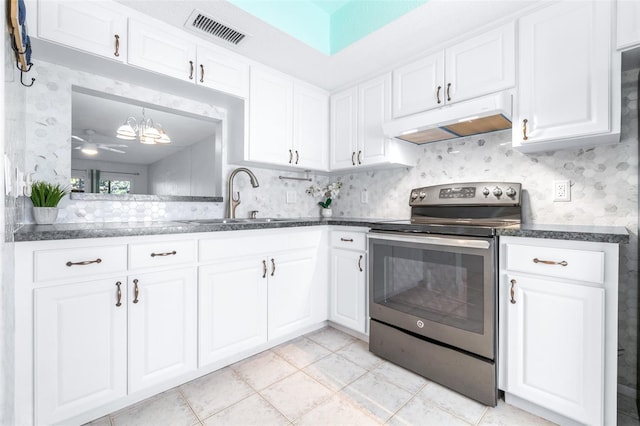 820 Patricia Ave Unit 207, Dunedin, FL 34698 - kitchen with stainless steel electric range oven, under cabinet range hood, a sink, white cabinets, and dark countertops