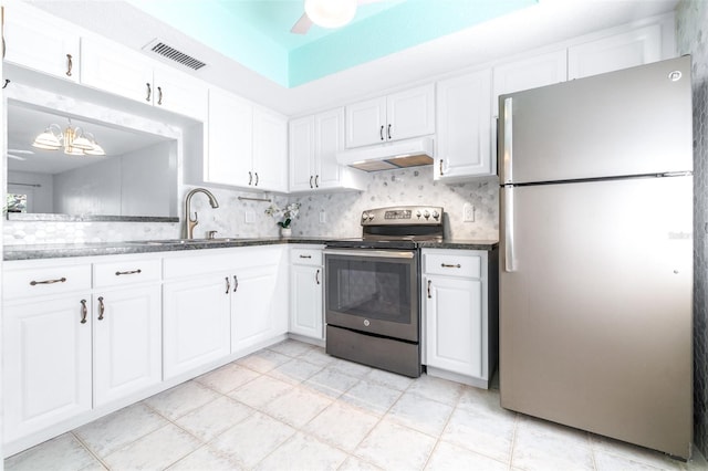 820 Patricia Ave Unit 207, Dunedin, FL 34698 - kitchen with appliances with stainless steel finishes, under cabinet range hood, a sink, and white cabinetry