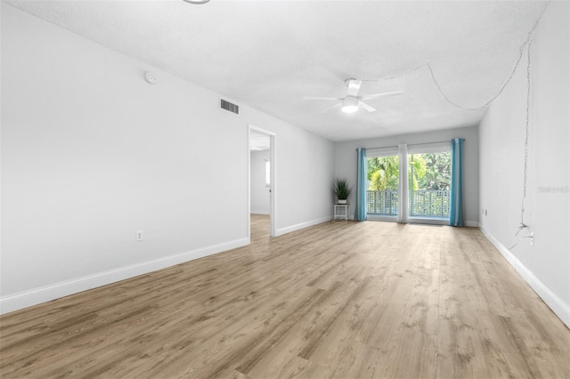 820 Patricia Ave Unit 207, Dunedin, FL 34698 - unfurnished room featuring ceiling fan, light wood-style floors, baseboards, and a textured ceiling