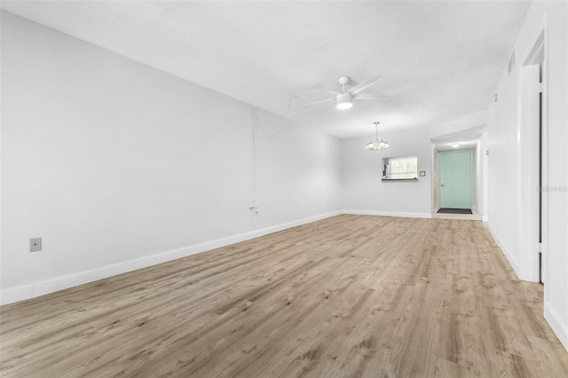 820 Patricia Ave Unit 207, Dunedin, FL 34698 - spare room with a chandelier, light wood-style floors, a textured ceiling, baseboards, and ceiling fan