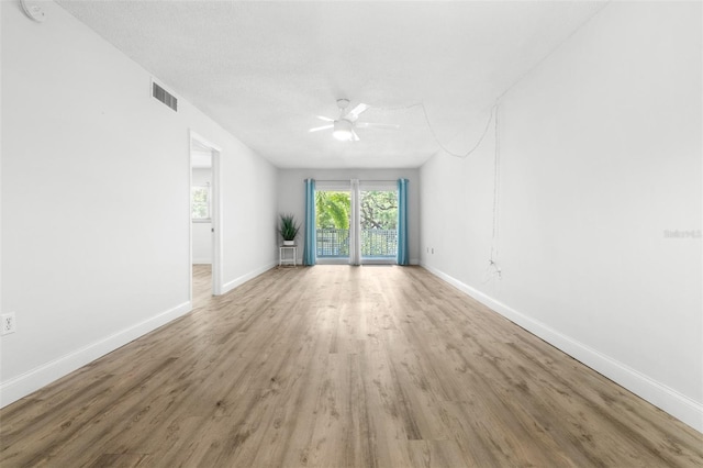 820 Patricia Ave Unit 207, Dunedin, FL 34698 - empty room with a ceiling fan, wood finished floors, baseboards, and a smoke detector