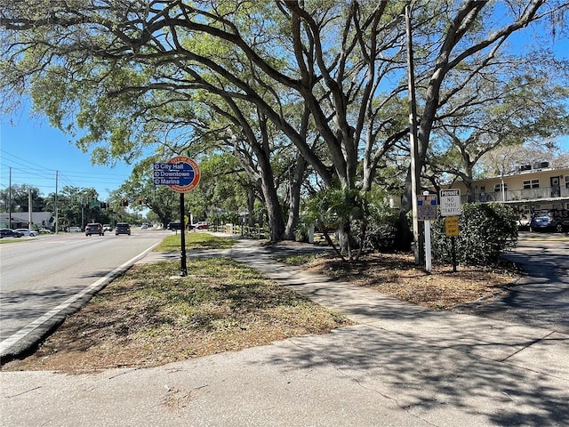 820 Patricia Ave Unit 207, Dunedin, FL 34698 - view of asphalt road with traffic signs and sidewalks