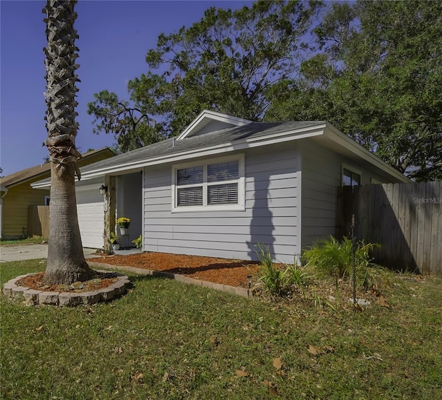 view of front of home featuring a front yard and a garage