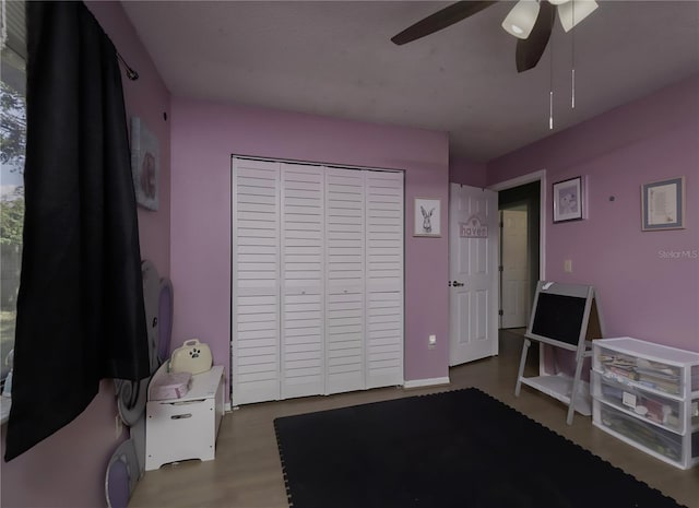 bedroom featuring hardwood / wood-style flooring, ceiling fan, and a closet