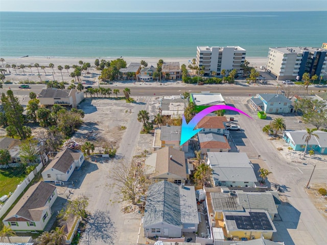 aerial view with a water view and a beach view