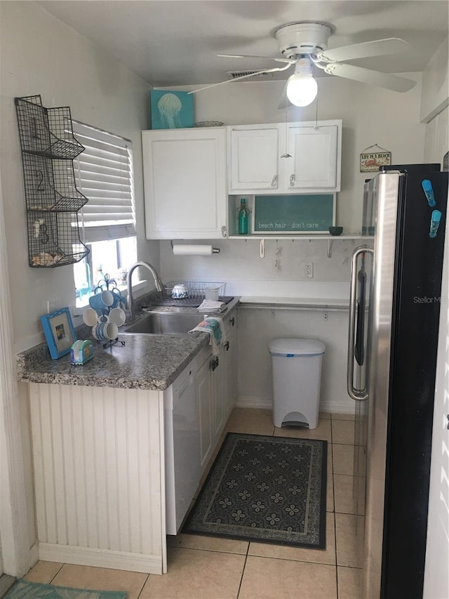78 146th Ave E, Madeira Beach, FL 33708 - kitchen featuring freestanding refrigerator, ceiling fan, dishwasher, light tile patterned floors, and white cabinets