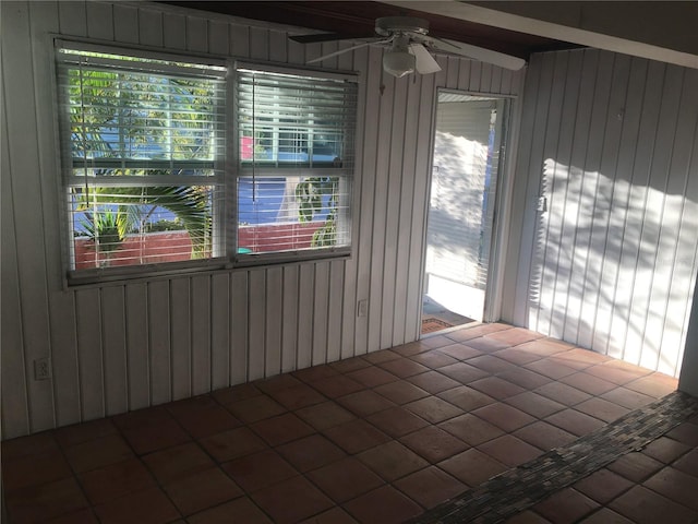 78 146th Ave E, Madeira Beach, FL 33708 - spare room with healthy amount of natural light, ceiling fan, and wood walls