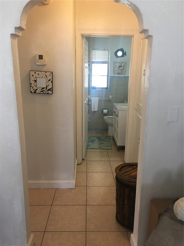 78 146th Ave E, Madeira Beach, FL 33708 - hallway with light tile patterned flooring and baseboards
