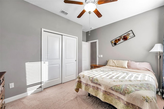 bedroom with light carpet, a closet, and ceiling fan