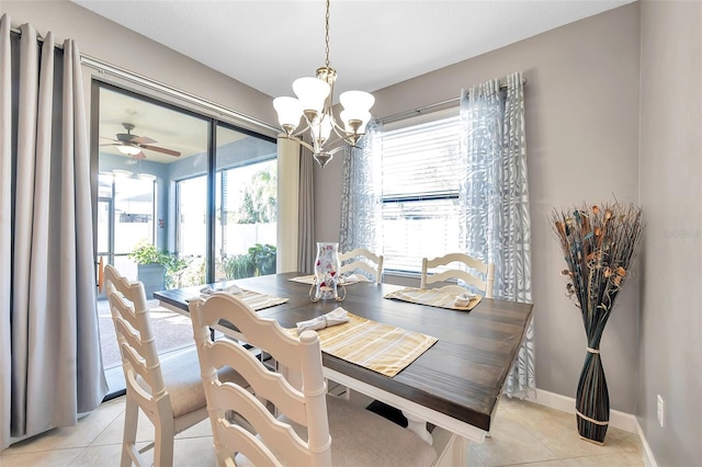 tiled dining area with ceiling fan with notable chandelier