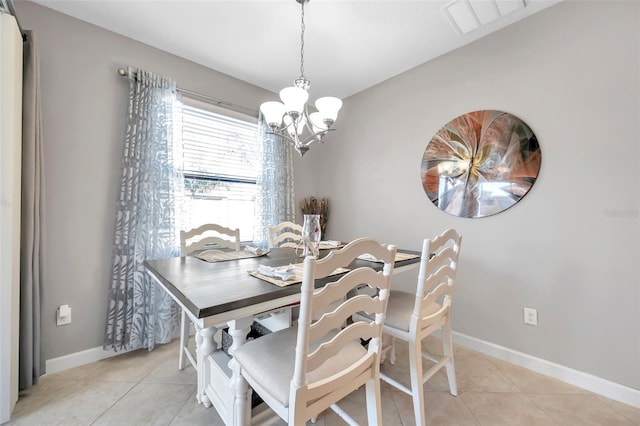 tiled dining area with a chandelier