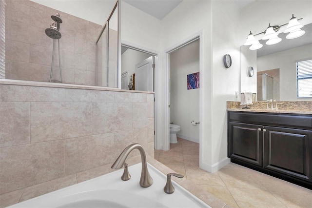 full bathroom featuring tile patterned flooring, shower with separate bathtub, vanity, and toilet