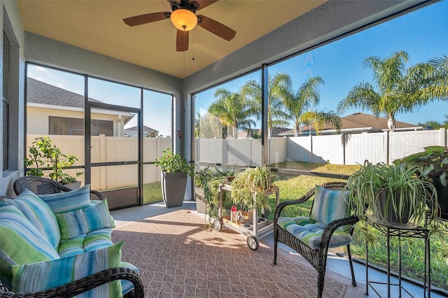 sunroom featuring ceiling fan