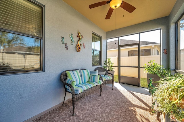 sunroom featuring ceiling fan