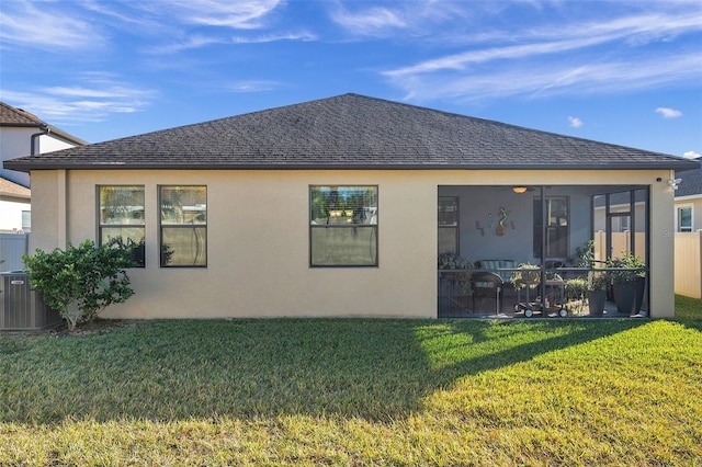 back of property with a lawn, a sunroom, and cooling unit