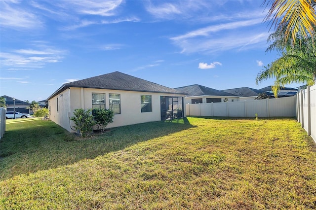 rear view of house with a yard