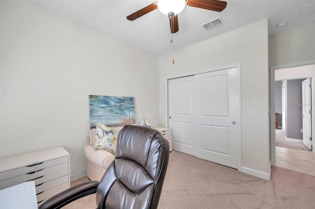 carpeted office with ceiling fan