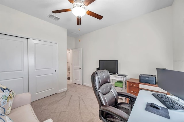 carpeted office space with ceiling fan