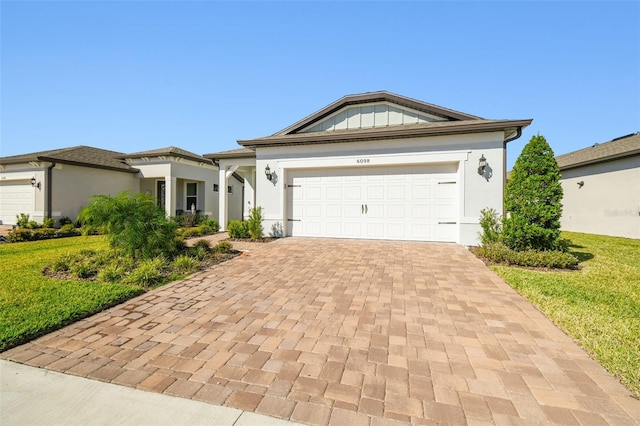 view of front of house with a front yard and a garage