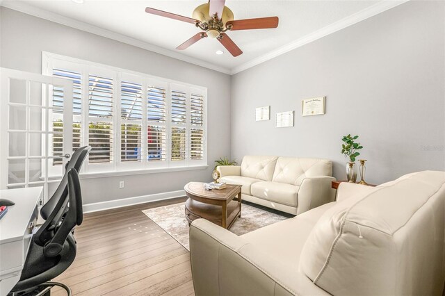 interior space with hardwood / wood-style flooring, ceiling fan, and ornamental molding