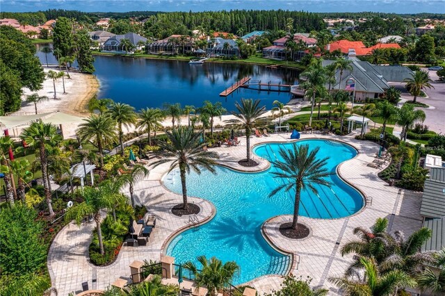 view of swimming pool with a water view and a patio