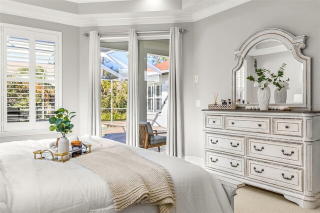 bedroom featuring ornamental molding, access to outside, and multiple windows