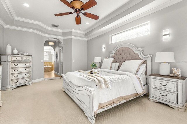 bedroom with light colored carpet, ensuite bath, ceiling fan, and crown molding