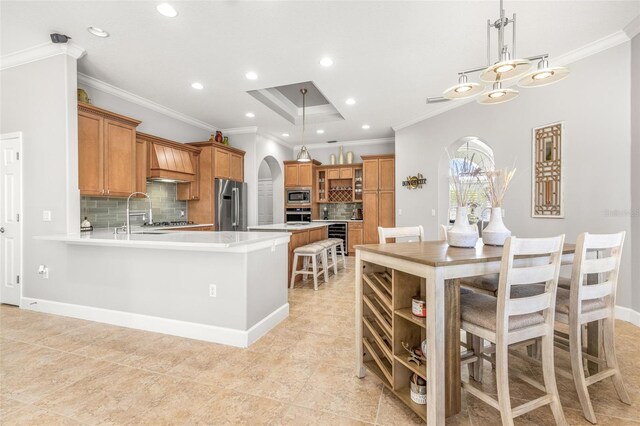 kitchen with stainless steel appliances, tasteful backsplash, and ornamental molding