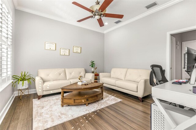 living room featuring ceiling fan, dark hardwood / wood-style flooring, and ornamental molding