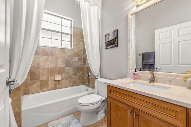 full bathroom featuring tile patterned flooring, vanity, toilet, and shower / bath combo with shower curtain