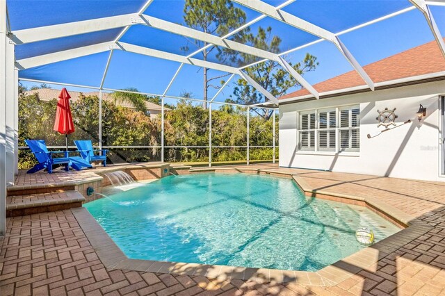 view of swimming pool featuring a patio area, pool water feature, and glass enclosure