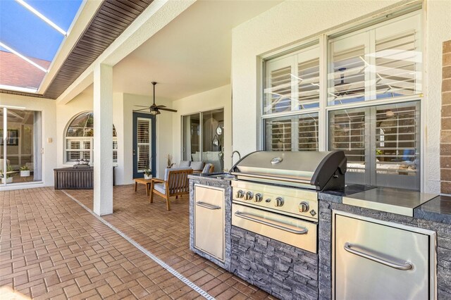 view of patio featuring an outdoor kitchen, a grill, sink, and ceiling fan