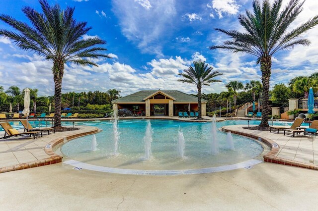 view of swimming pool featuring pool water feature and a patio area