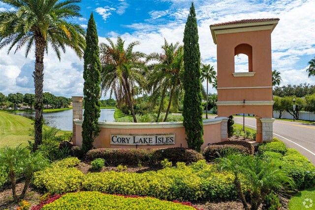 community / neighborhood sign with a water view