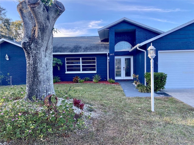 view of front of house with a garage, french doors, roof with shingles, and a front lawn