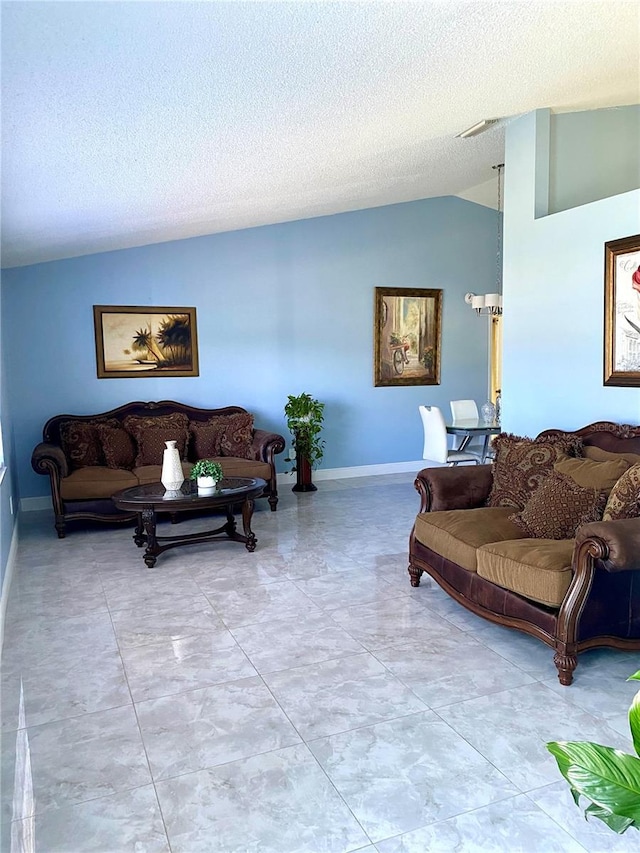 living room featuring a textured ceiling and lofted ceiling