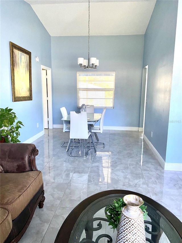 dining area with a notable chandelier and baseboards