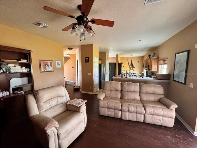 13404 Hampton Park Ct, Fort Myers, FL 33913 - living room featuring ceiling fan, dark wood-style flooring, baseboards, and a textured ceiling