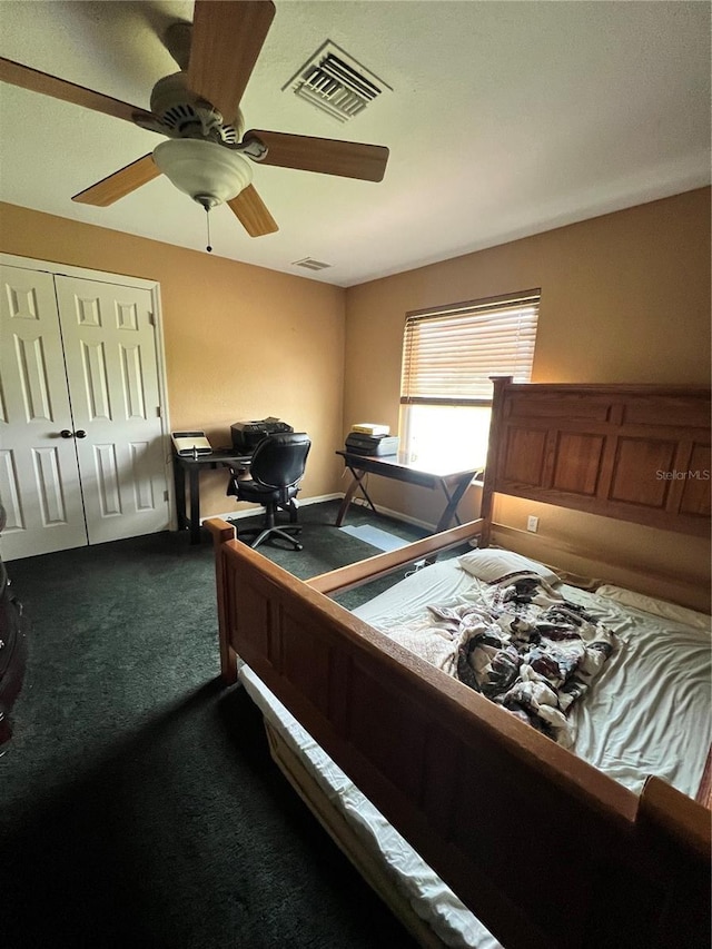 carpeted bedroom featuring ceiling fan and a closet