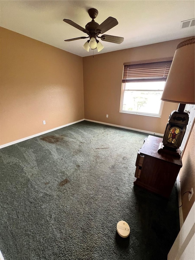 empty room featuring carpet flooring and ceiling fan