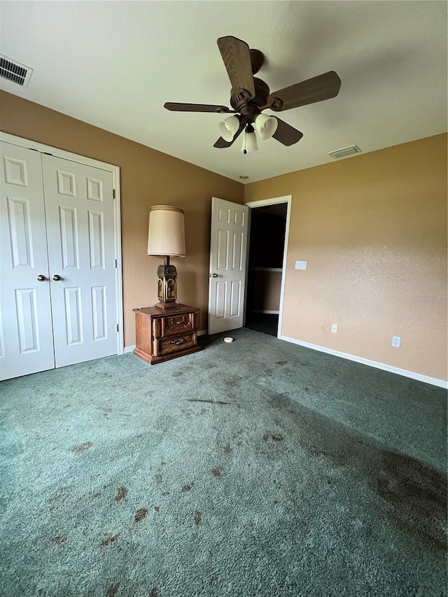 unfurnished bedroom with ceiling fan, a closet, and carpet floors