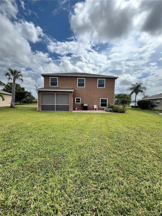 13404 Hampton Park Ct, Fort Myers, FL 33913 - back of property featuring a yard, stucco siding, a sunroom, and a garage