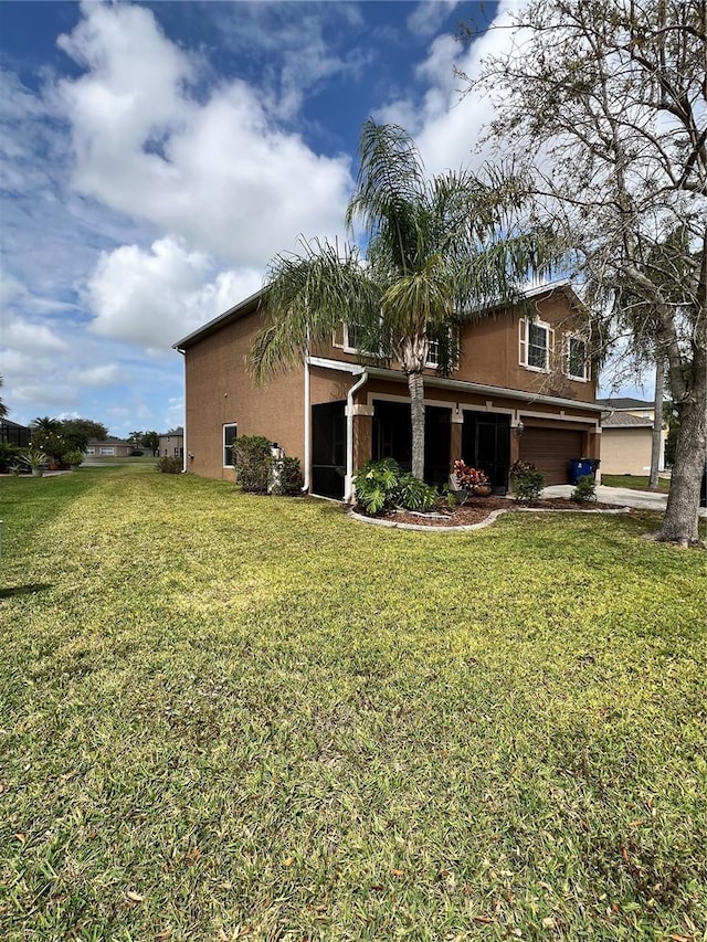 exterior space featuring a garage and a lawn