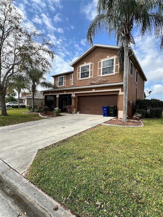 view of front of home with a garage and a front lawn