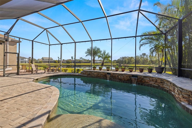 view of pool with a patio, pool water feature, and glass enclosure