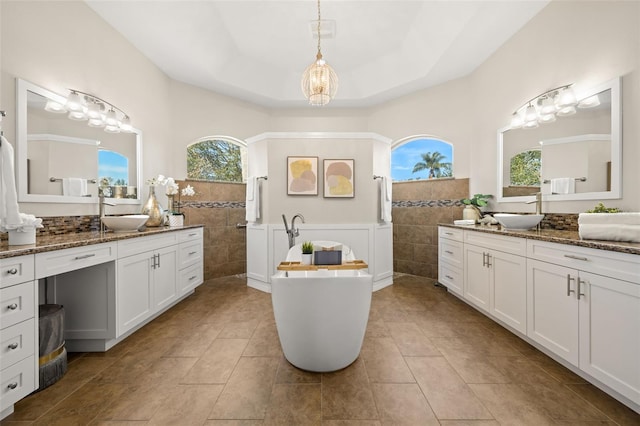 bathroom featuring tile patterned floors, plenty of natural light, and tile walls