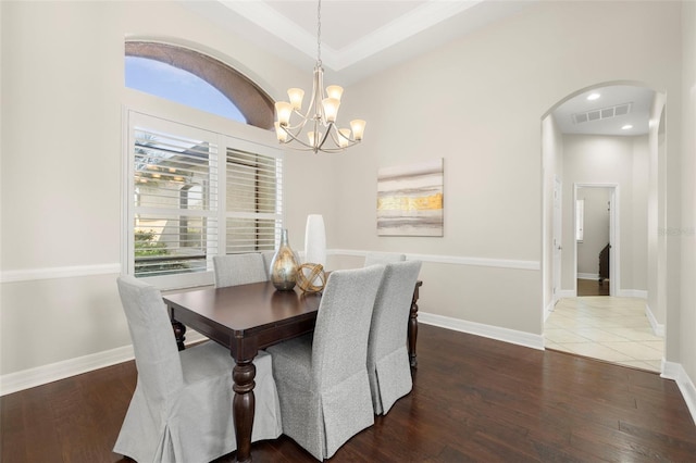 dining area with a chandelier and dark wood-type flooring